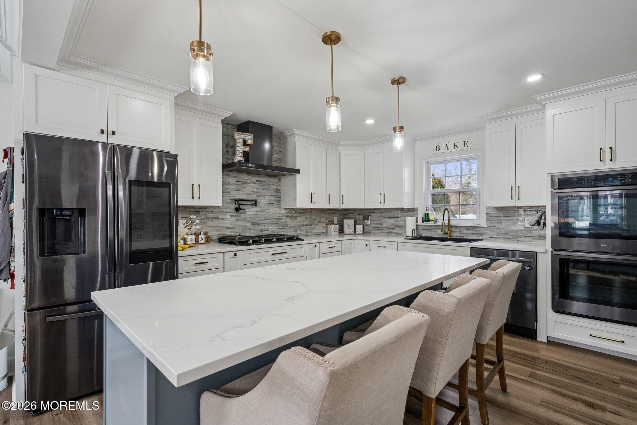 121 Corson Avenue Hamilton, NJ 08619 - Photo 6 of 32 a kitchen with kitchen island a refrigerator a stove a sink and a center island