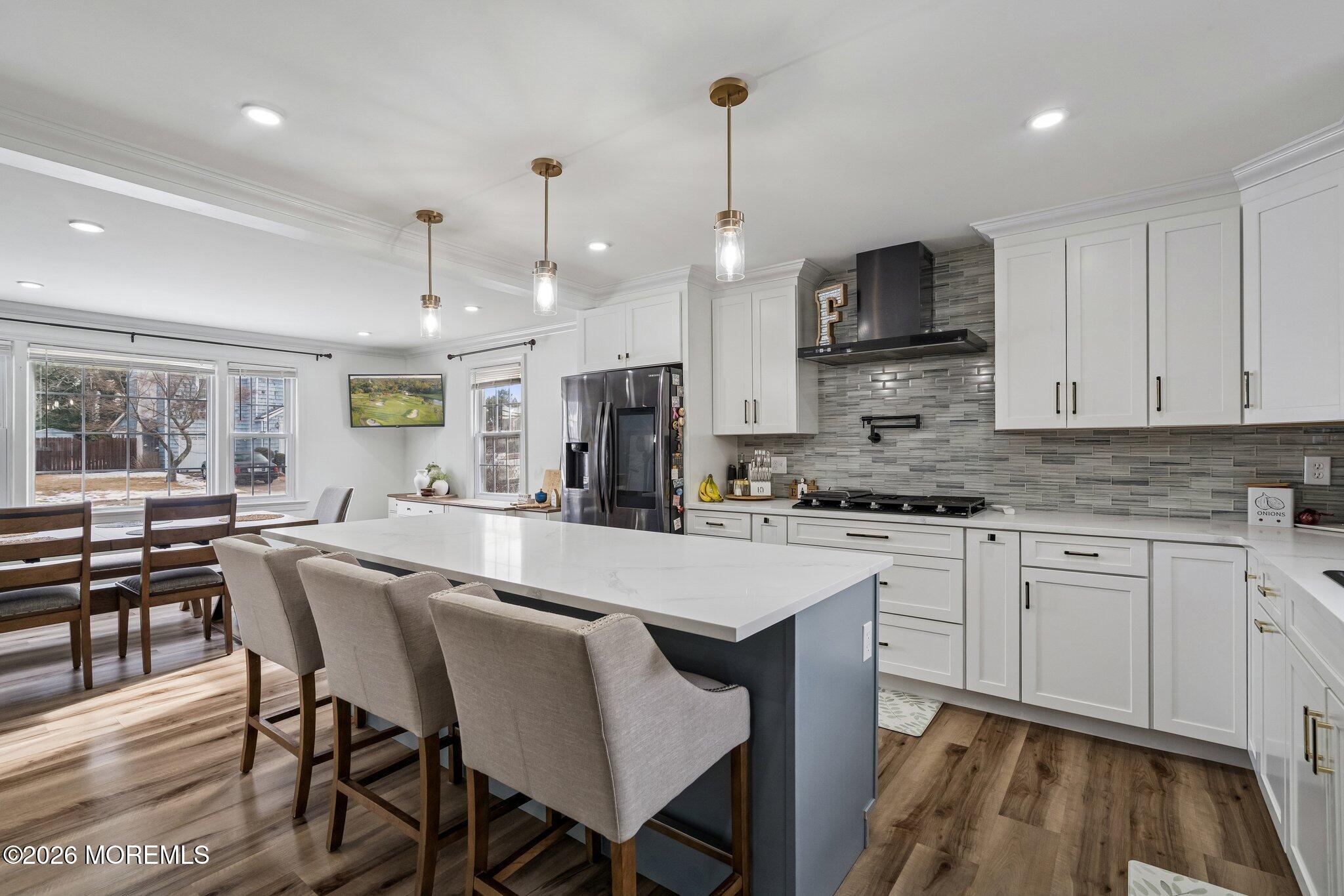 121 Corson Avenue Hamilton, NJ 08619 - Photo 10 of 32 a large kitchen with stainless steel appliances kitchen island granite countertop a stove a sink a dining table and chairs