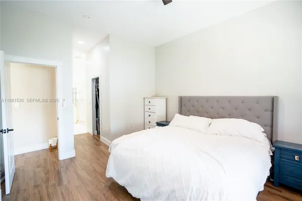 a bedroom with a bed and wooden floor