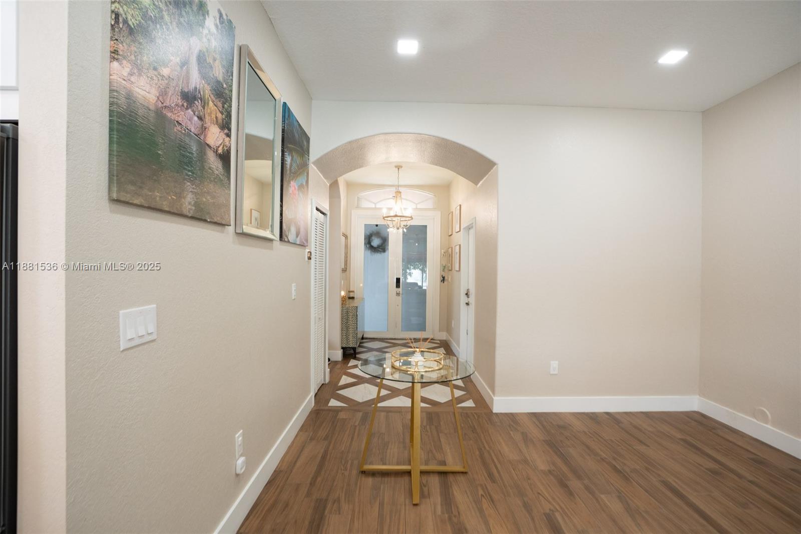 13000 Southwest 52nd Street Miramar, FL 33027 - Photo 3 of 16 a view of a hallway with wooden floor and a living room