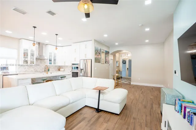 a living room with furniture and a wooden floor