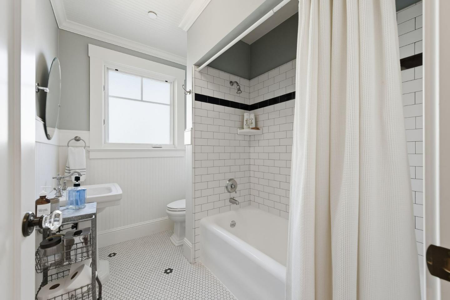 1212 Mills Avenue Burlingame, CA 94010 - Photo 11 of 32 a bathroom with a toilet a sink and bathtub