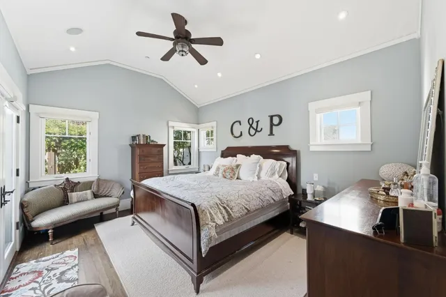 a bedroom with a bed a couch and a chandelier