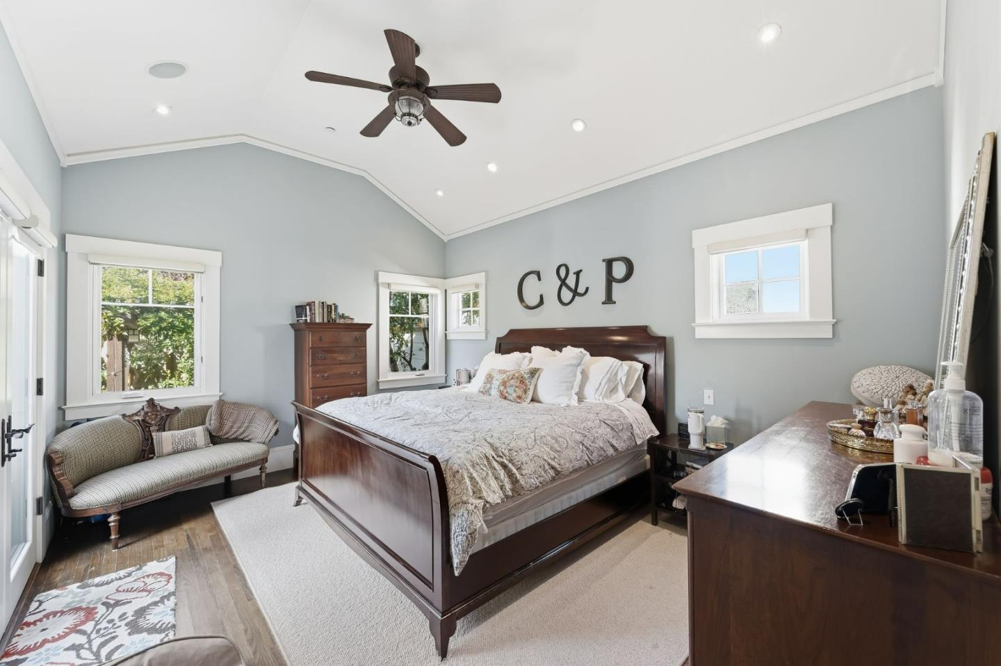 1212 Mills Avenue Burlingame, CA 94010 - Photo 16 of 32 a bedroom with a bed a couch and a chandelier