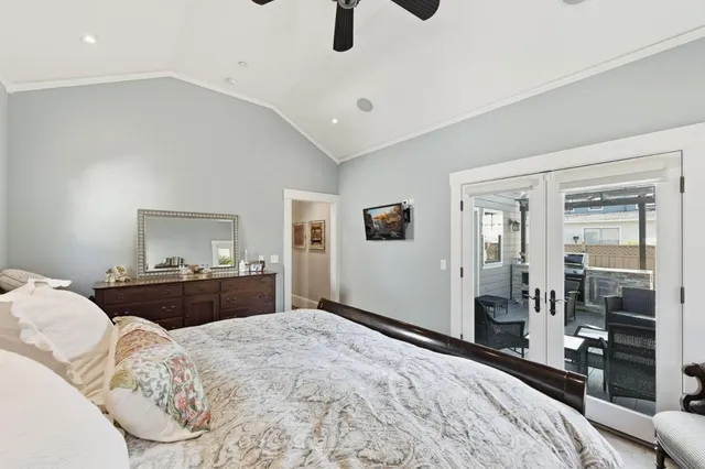 a bedroom with a bed and dresser with mirror