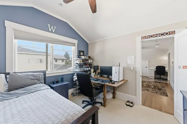 a bedroom with a bed and a desk