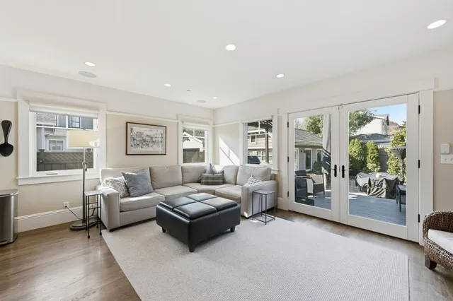 a living room with furniture and large window