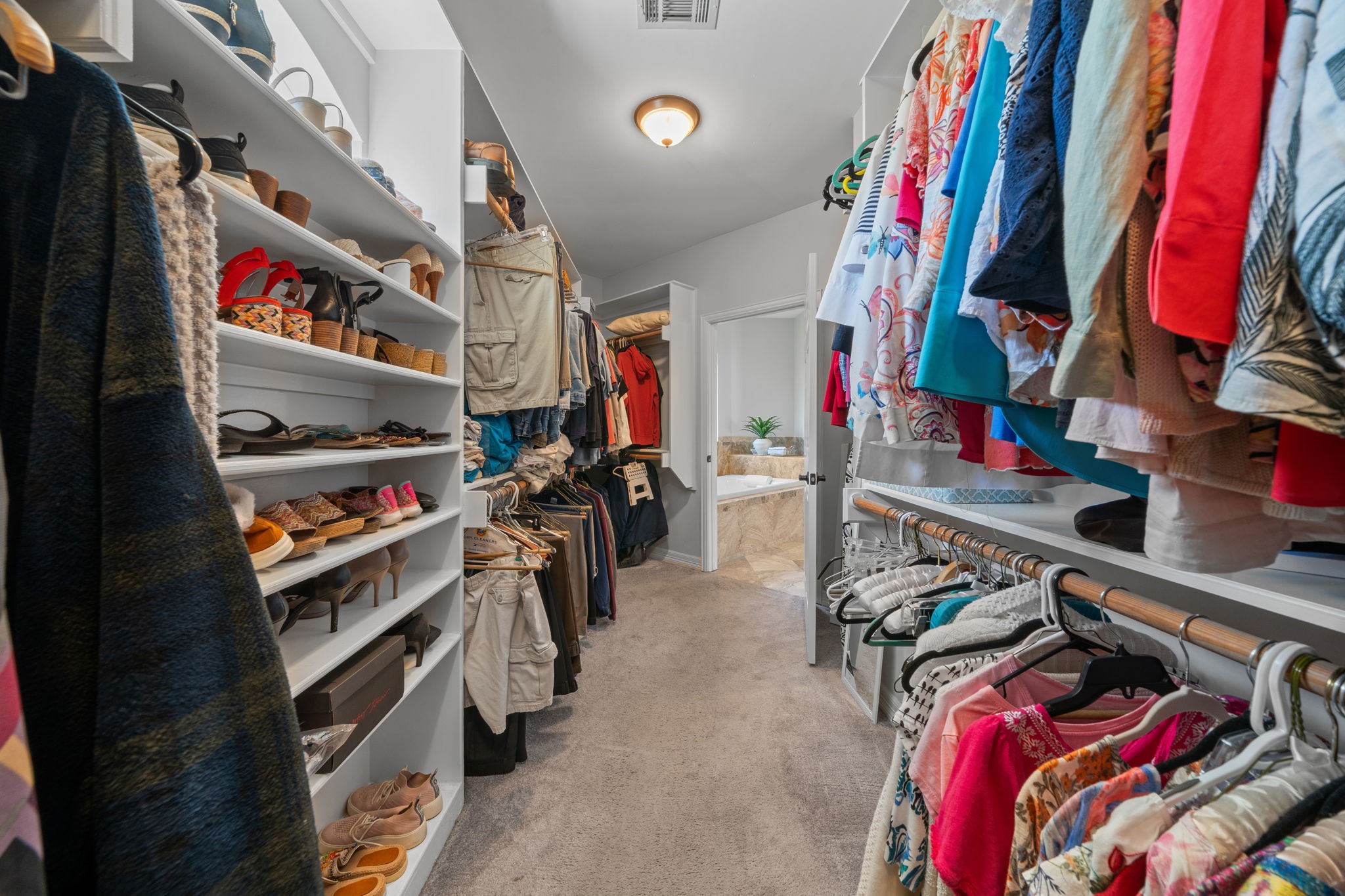 18355 Burkhardt Road Tomball, TX 77377 - Photo 27 of 50 a view of walk in closet with clothes and shoes