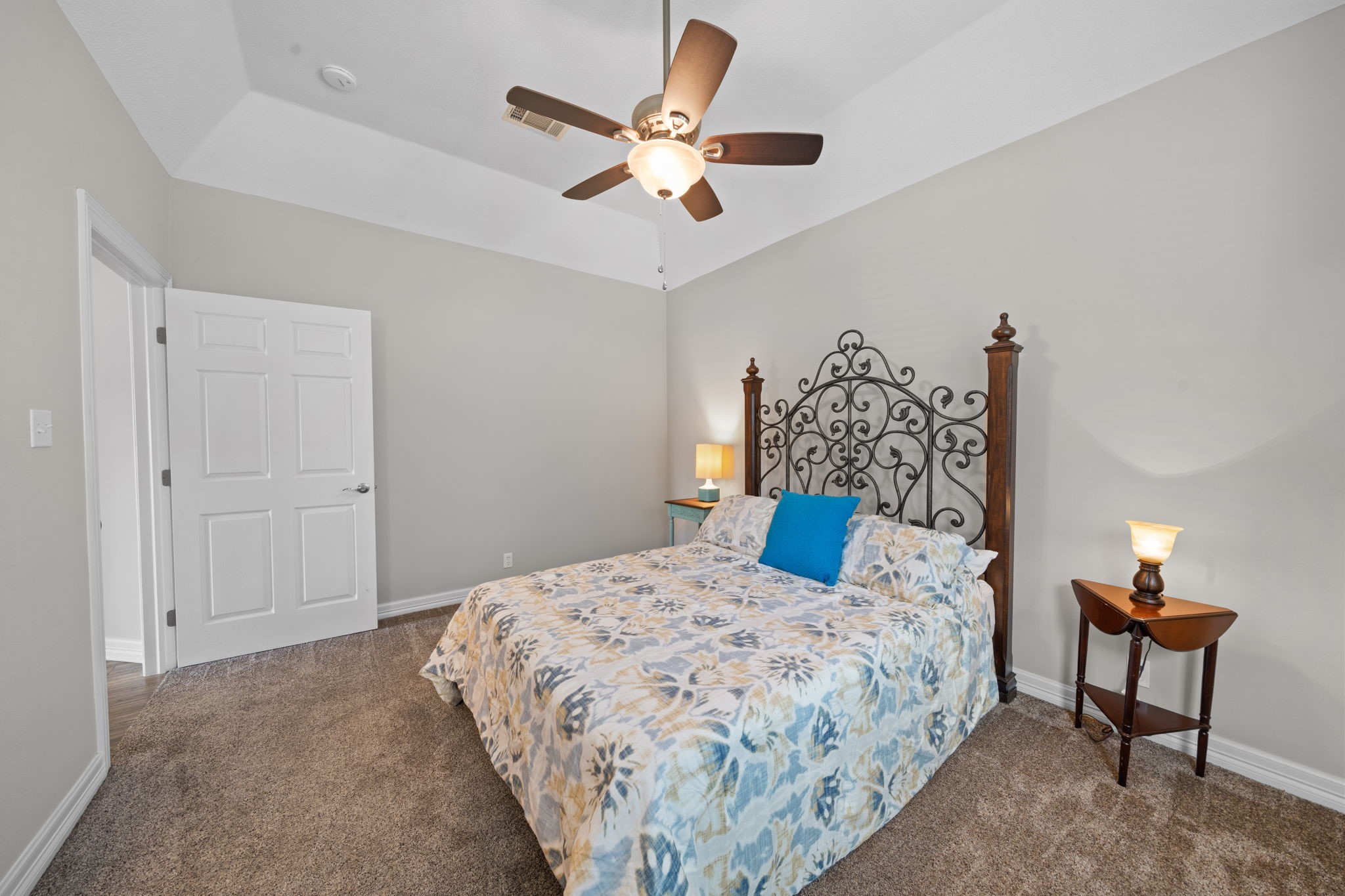 18355 Burkhardt Road Tomball, TX 77377 - Photo 29 of 50 a bedroom with a bed and a chandelier