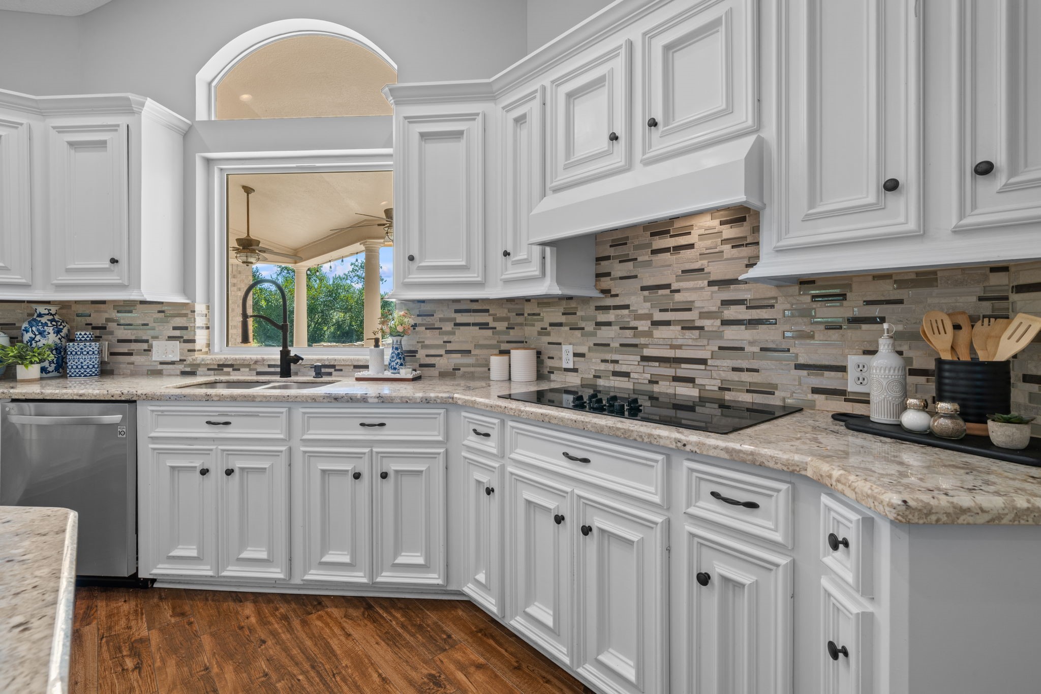 18355 Burkhardt Road Tomball, TX 77377 - Photo 7 of 50 a kitchen with granite countertop white cabinets and white appliances