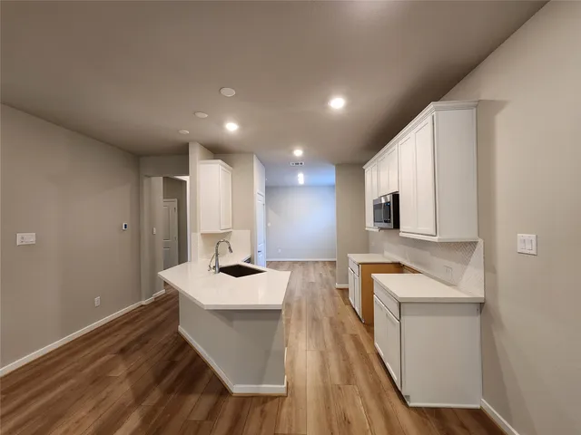 a kitchen with a sink stove and cabinets