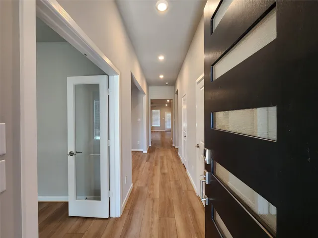 a view of hallway with wooden floor