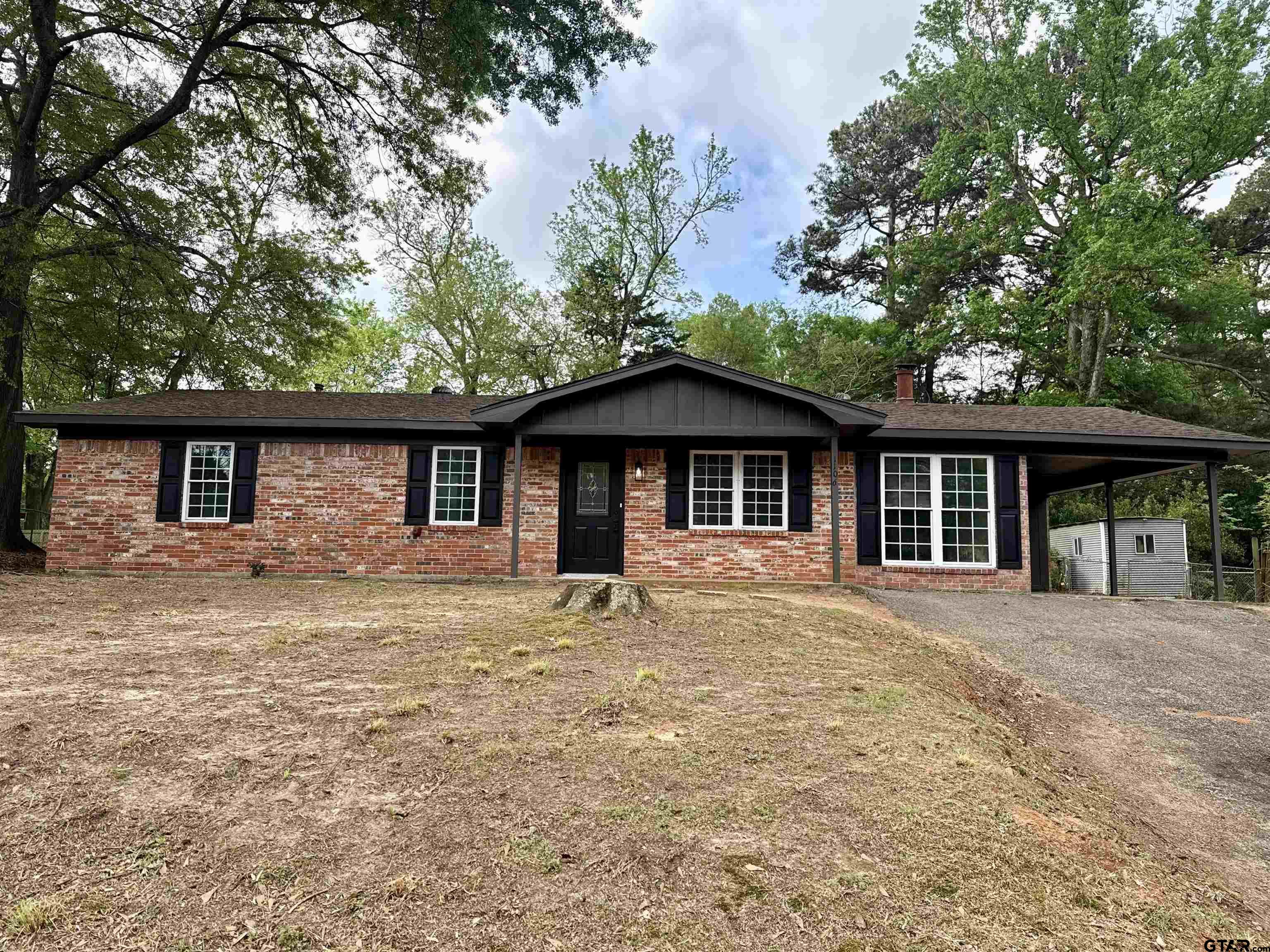 1106 Annette Drive Longview, TX 75604 - Photo 1 of 21 a front view of house with yard barbeque oven and trees