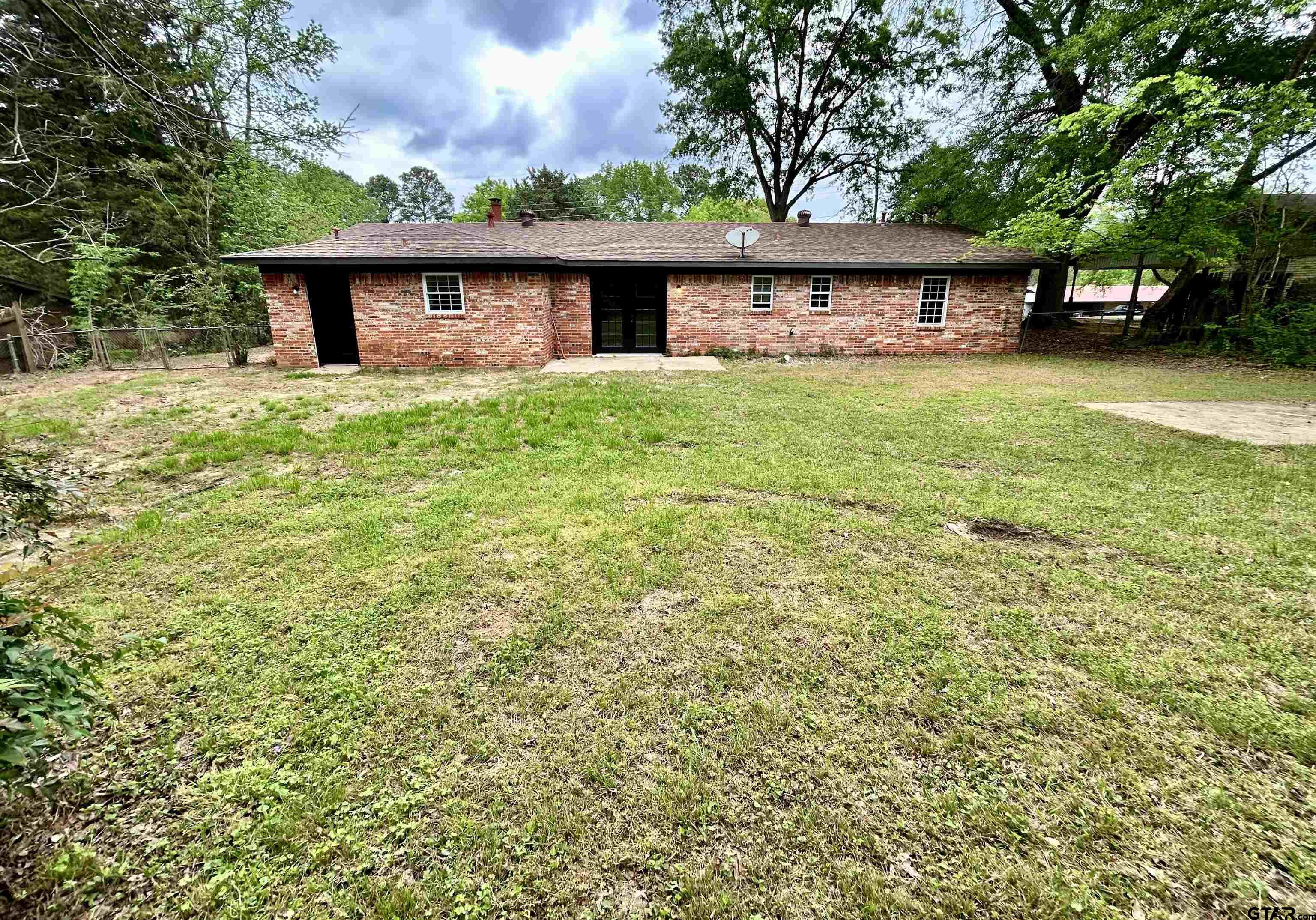 1106 Annette Drive Longview, TX 75604 - Photo 19 of 21 a view of a house with a yard and sitting area