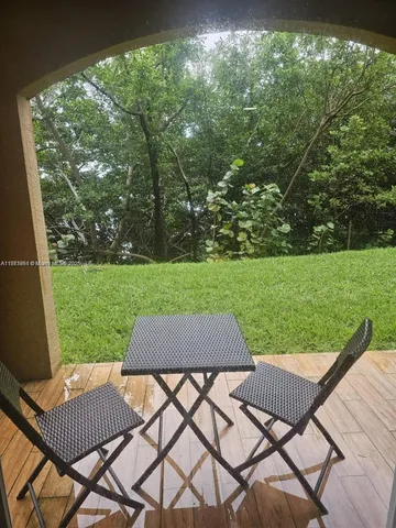 a view of a chairs and table in the yard