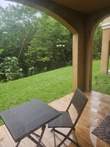a view of a patio with a yard