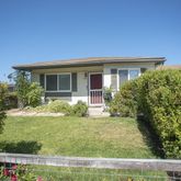 a view of house with a yard