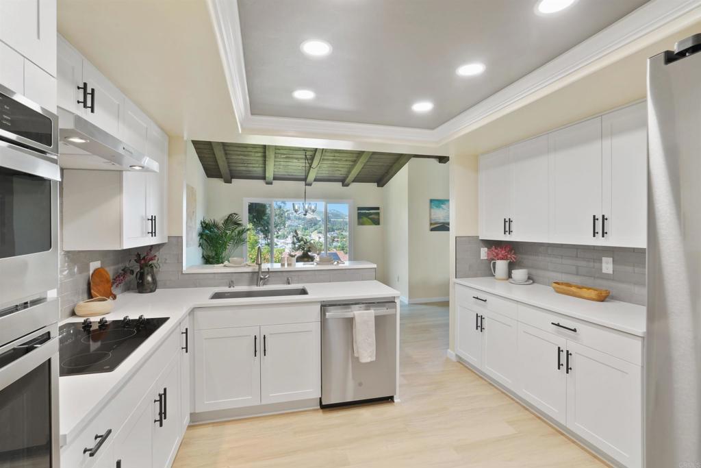1126 Hermosillo Glen Escondido, CA 92026 - Photo 2 of 32 a kitchen with a sink stove and cabinets