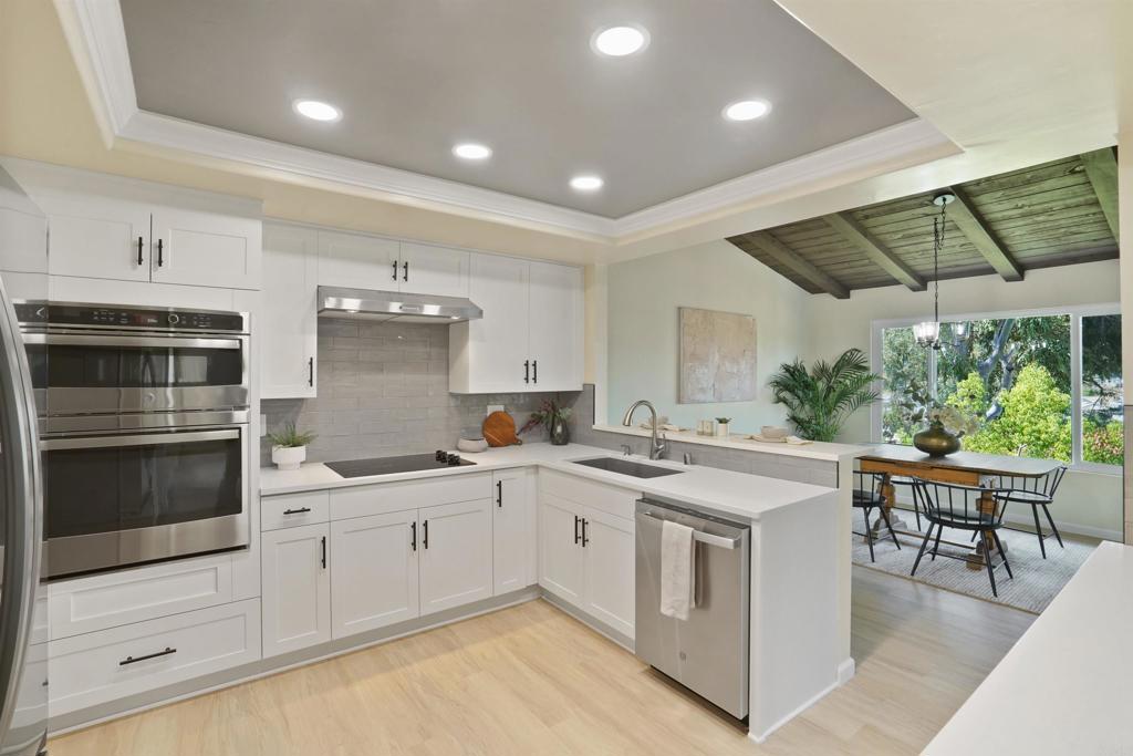 1126 Hermosillo Glen Escondido, CA 92026 - Photo 3 of 32 a kitchen with a stove and white cabinets