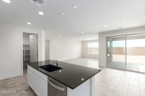 a kitchen with stainless steel appliances granite countertop a sink and a stove