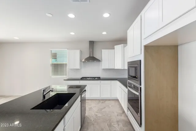 a kitchen with a sink stove and refrigerator