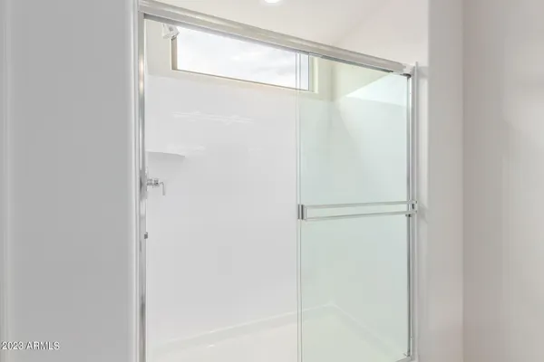 a bathroom with a glass shower door