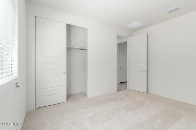 an empty room with closet area