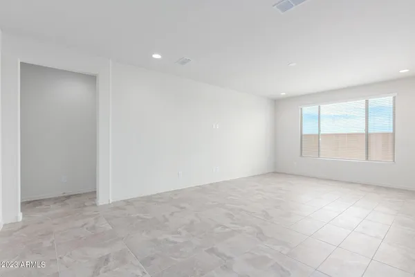 an empty room with a empty space and windows