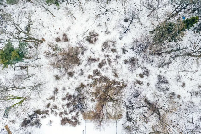 a wooden bench sitting in front of a building