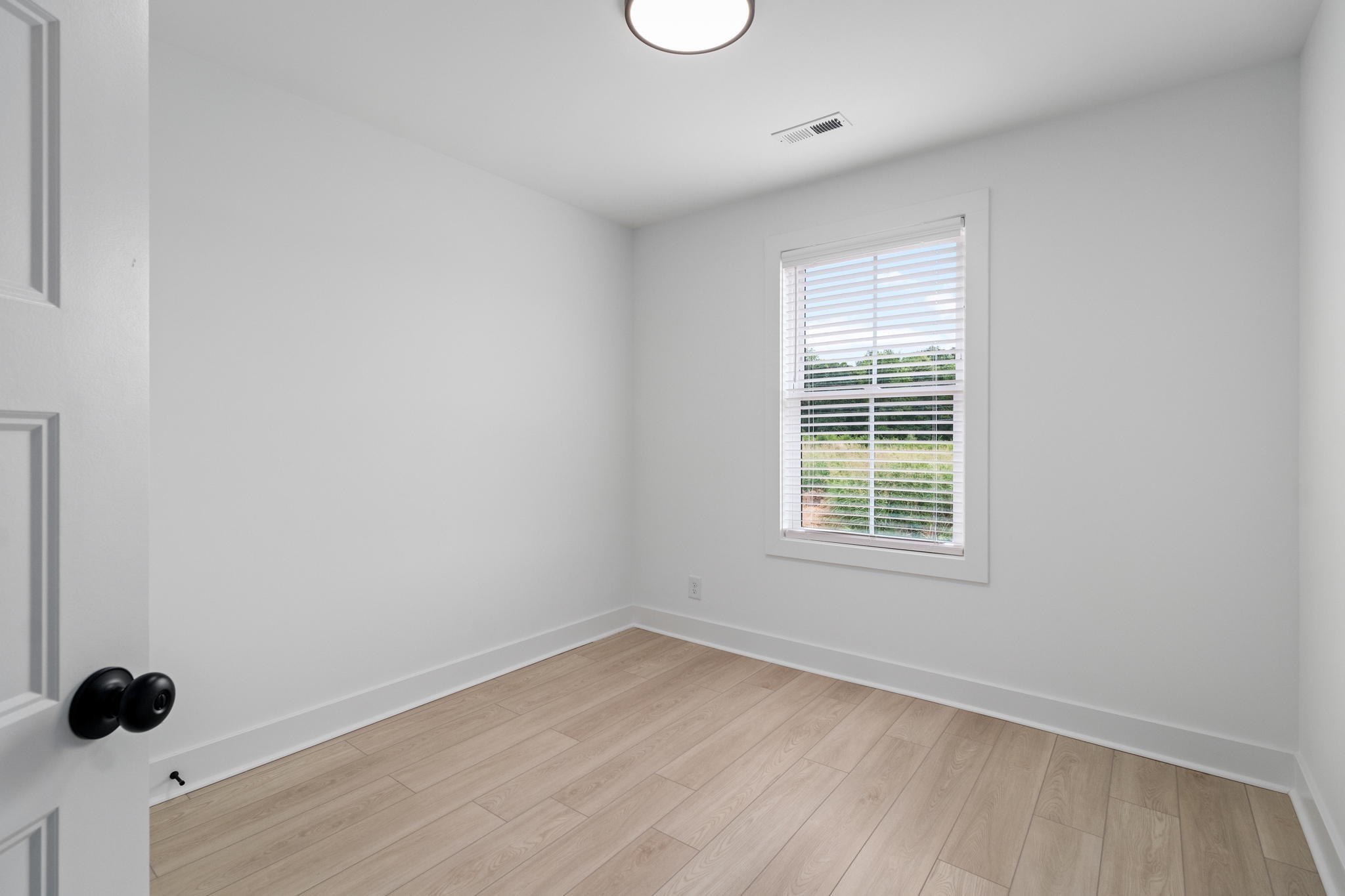 725 Hornbuckle Road, Unit O3 Clarksville, TN 37043 - Photo 16 of 38 wooden floor in an empty room with a window