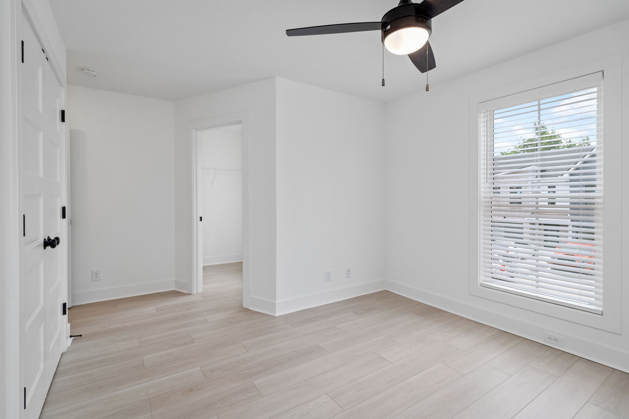 725 Hornbuckle Road, Unit O3 Clarksville, TN 37043 - Photo 20 of 38 a view of an empty room with a window and wooden floor