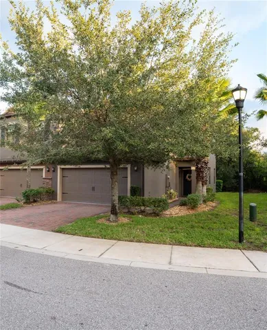 a house that has a tree in front of it