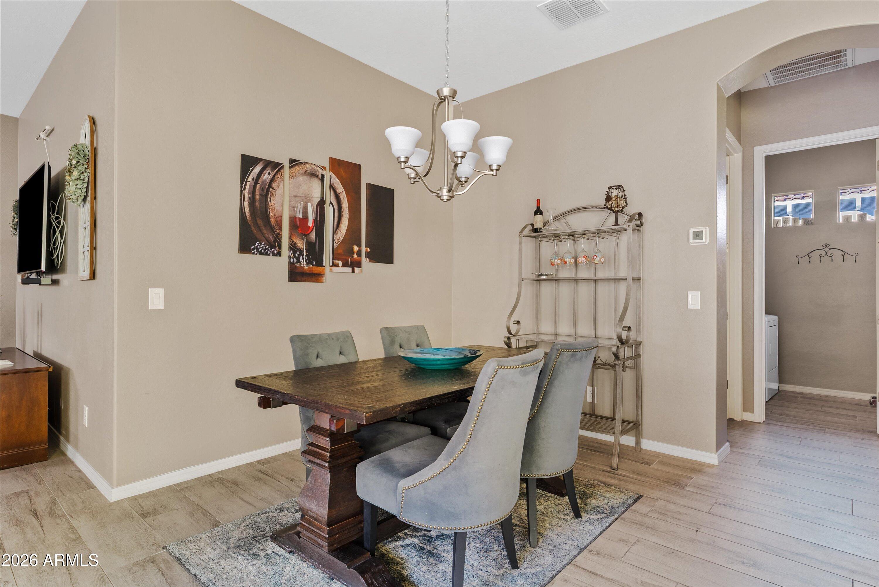 4461 East Jones Street Gilbert, AZ 85295 - Photo 16 of 40 a view of a dining room with furniture and wooden floor