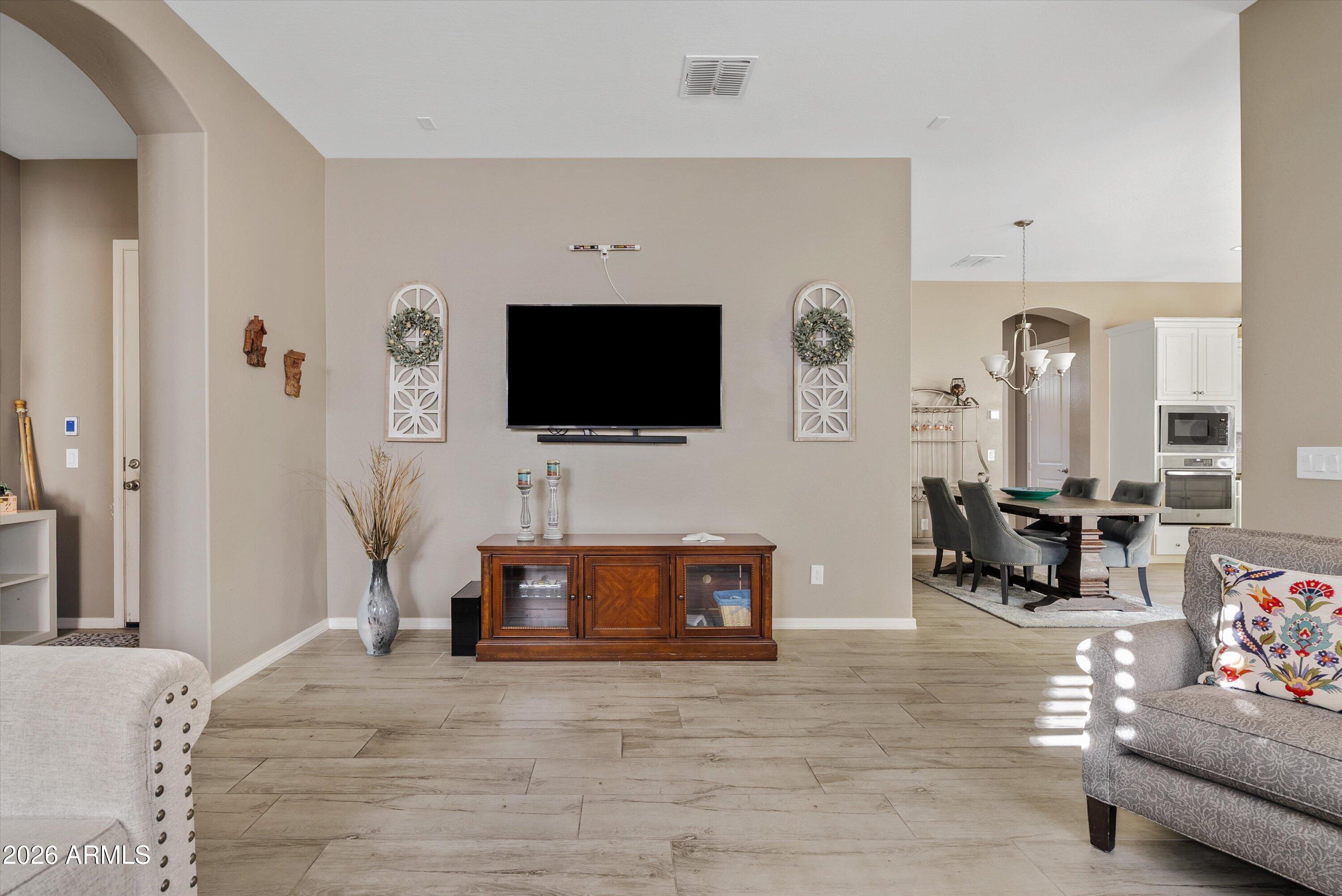4461 East Jones Street Gilbert, AZ 85295 - Photo 21 of 40 a living room with furniture and a flat screen tv