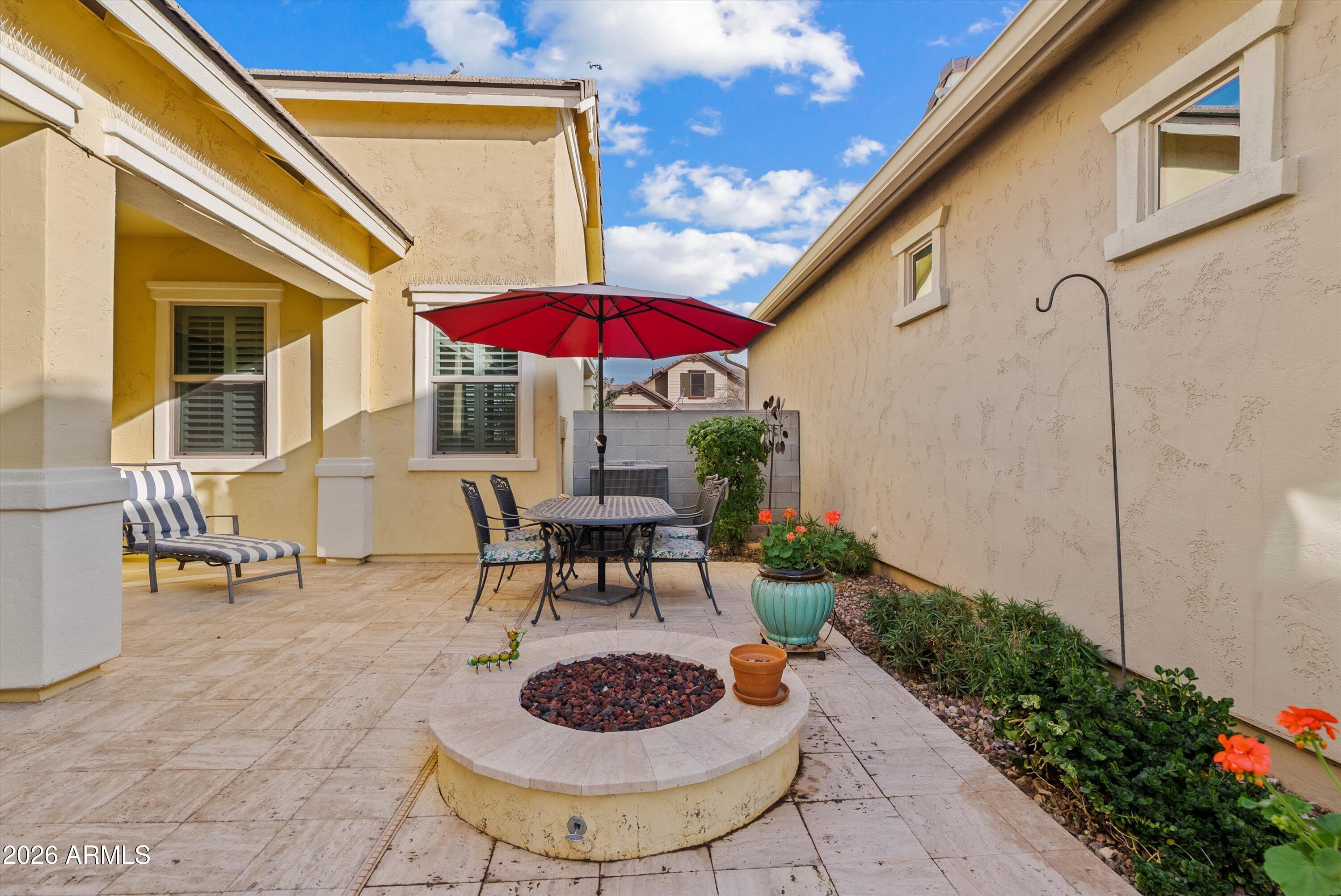 4461 East Jones Street Gilbert, AZ 85295 - Photo 29 of 40 a view of a patio with table and chairs under an umbrella