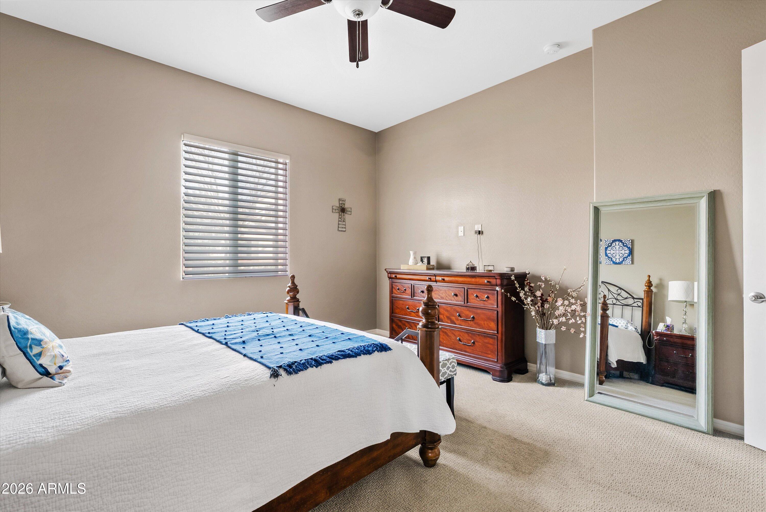 4461 East Jones Street Gilbert, AZ 85295 - Photo 7 of 40 a bedroom with a bed and a chandelier