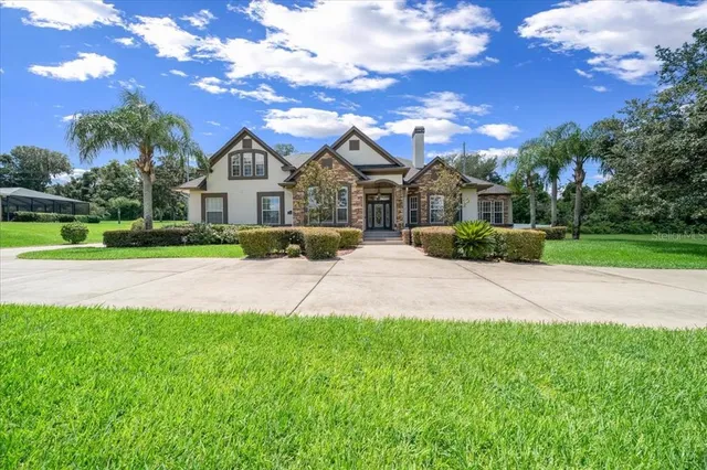a front view of house with yard and green space