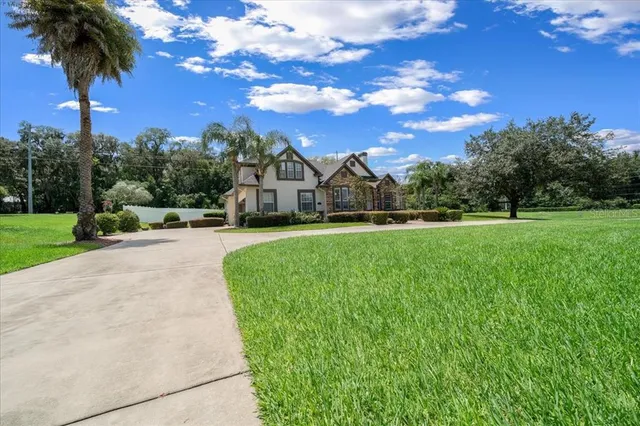 a large white kitchen with stainless steel appliances