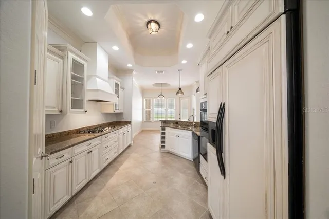 a view of empty room with a fireplace and a chandelier