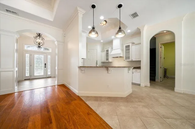 a spacious bathroom with a granite countertop sink a mirror and a bathtub