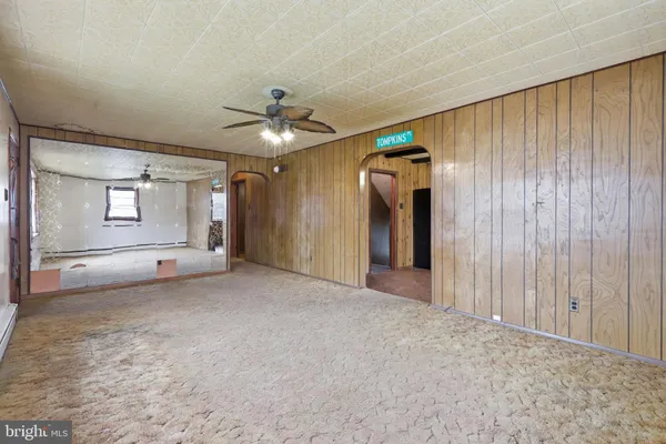 a view of a livingroom with a ceiling fan and window