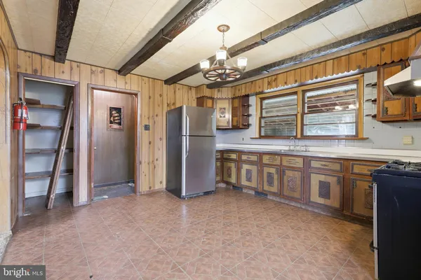 a kitchen with stainless steel appliances granite countertop a refrigerator and a stove