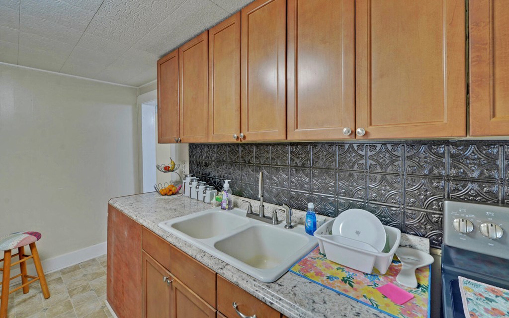 335 Elliott Road Murphy, NC 28906 - Photo 13 of 44 a kitchen with granite countertop a sink a stove and cabinets