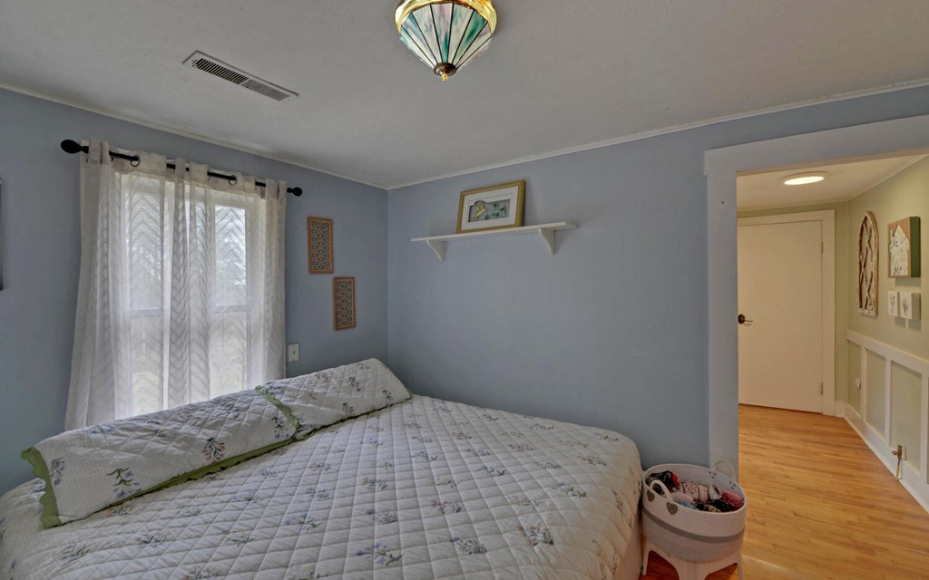 335 Elliott Road Murphy, NC 28906 - Photo 16 of 44 a bedroom with a bed and wooden floor