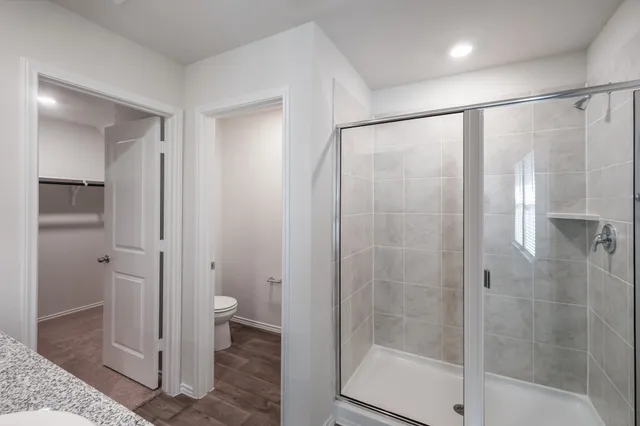 a bathroom with a shower and a toilet