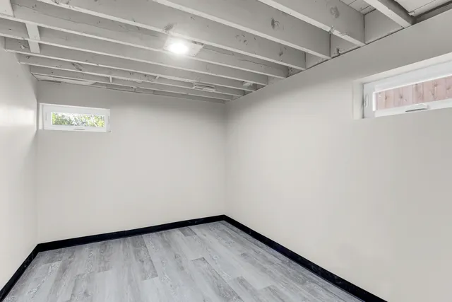 a view of a room with wooden floor