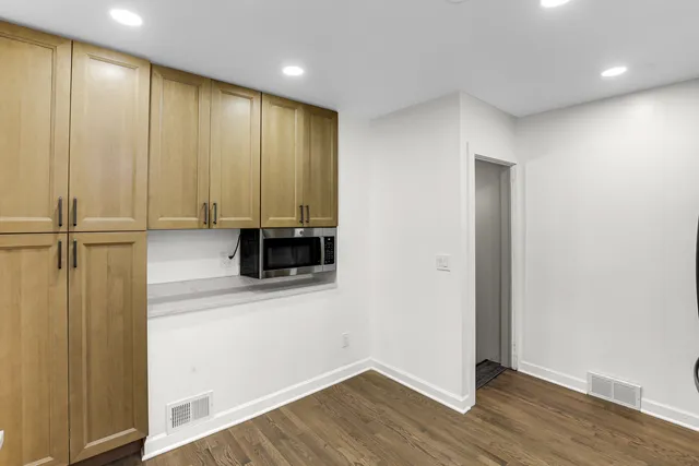 an empty room with wooden floor and a window
