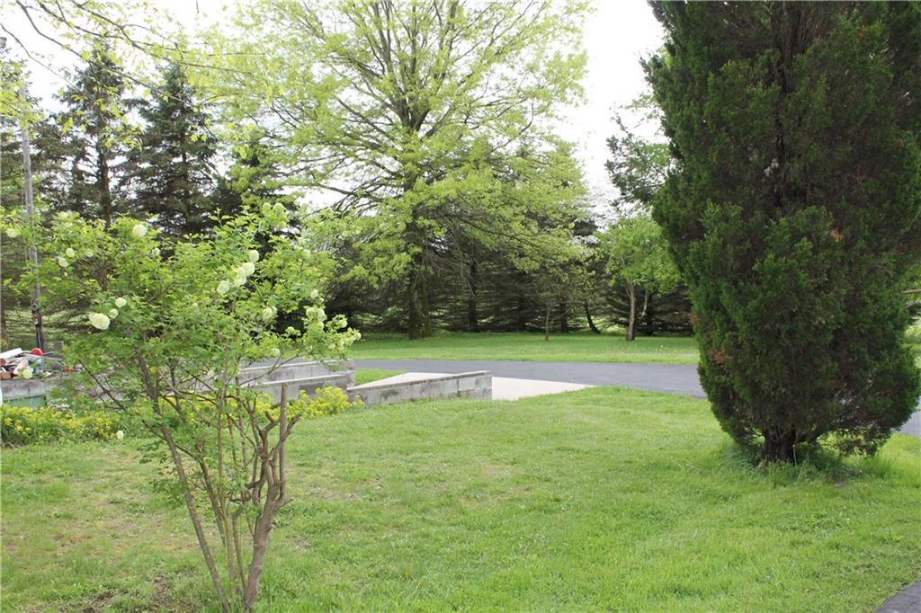 833 Greenville Road Mercer, PA 16137 - Photo 5 of 16 Private yard surrounded with Trees and Flowers with a Black Topped Circular Driveway