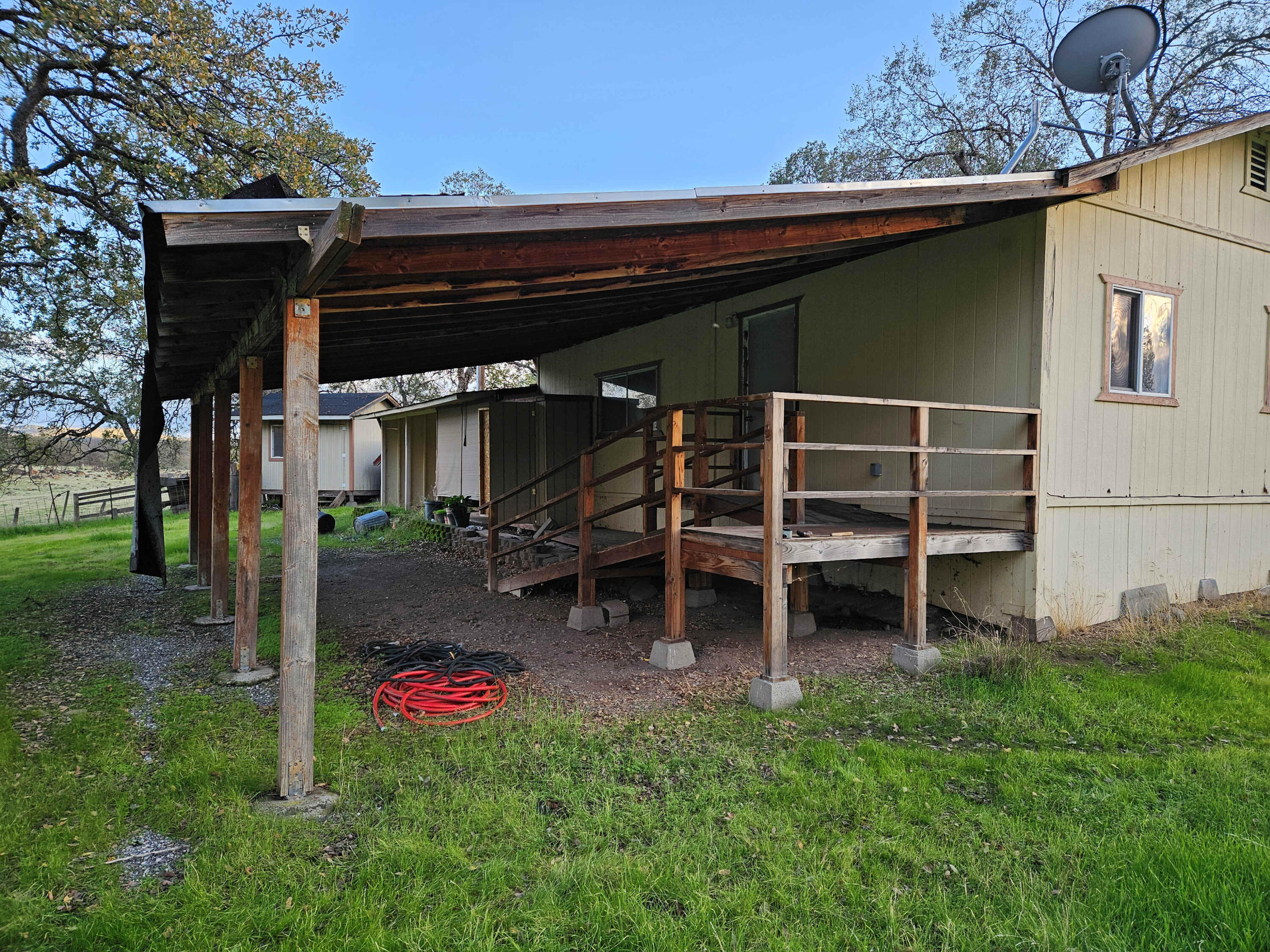 21675 Wildcat Road Shingletown, CA 96088 - Photo 35 of 65 a view of a wooden house with a big yard and large tree