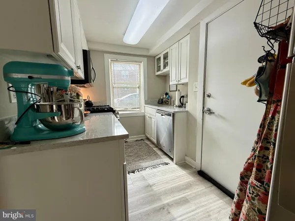 a kitchen with a sink appliances and cabinets